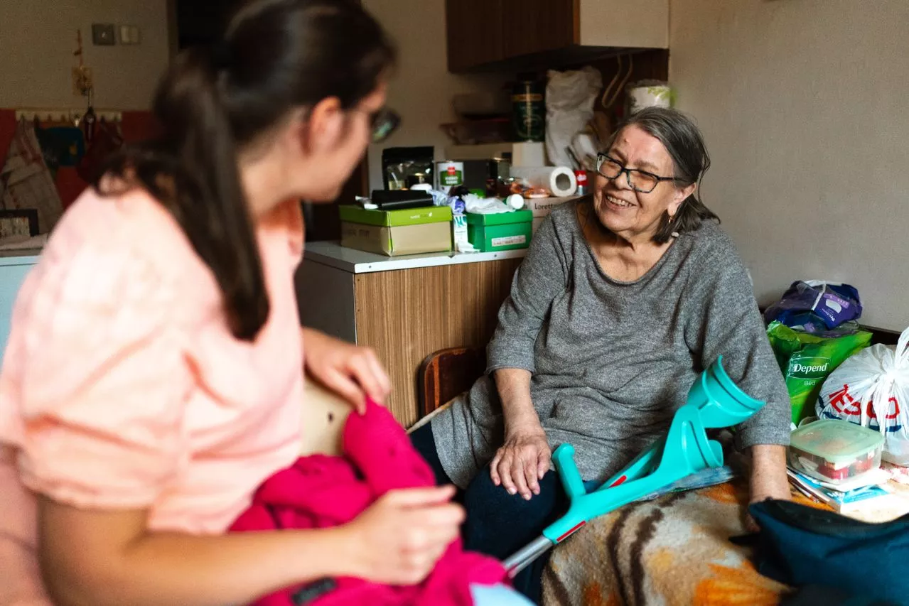 Caregiver speaking with family at home