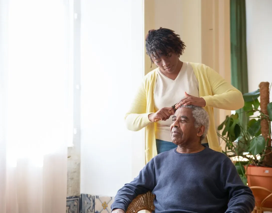 Caregiver supporting an older adult at home